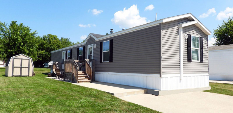 Modern manufactured home at Spring Lake community in Stevensville Michigan with private yard and outdoor seating area